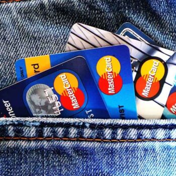 Credit cards visible in the pocket of a pair of blue denim jeans, showcasing a casual style and everyday convenience, conveying a theme of finance and accessibility.