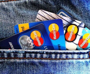 Credit cards visible in the pocket of a pair of blue denim jeans, showcasing a casual style and everyday convenience, conveying a theme of finance and accessibility.