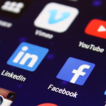 Social media apps displayed on a smartphone screen, showcasing popular platforms including Facebook, LinkedIn and Instagram.