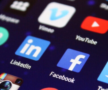 Social media apps displayed on a smartphone screen, showcasing popular platforms including Facebook, LinkedIn and Instagram.